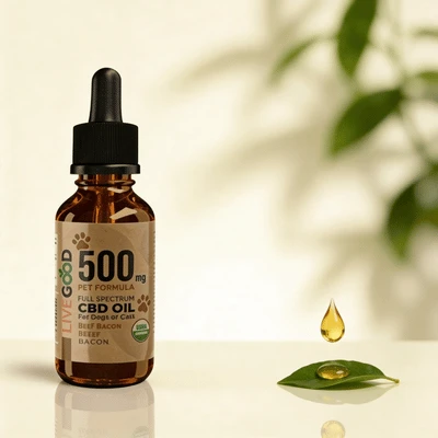 Flacon d'huile de CBD 500mg LiveGood pour chien et chat, posé dans un décor lumineux et naturel. Une goutte d'huile dorée tombe sur une feuille verte, symbolisant la pureté et la qualité du produit recommandé par VitalieBio pour apaiser les animaux.